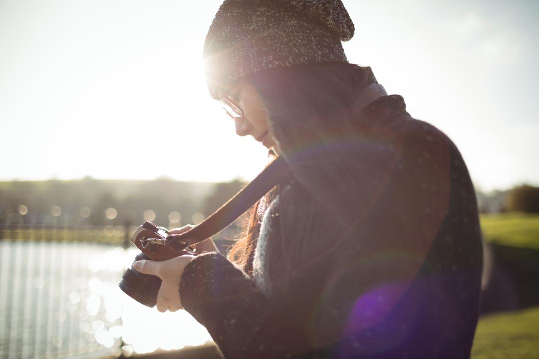 Image of a photographer looking at the photos they have taken on their camera - How does a blog for photographers differ from a classic blog - Image