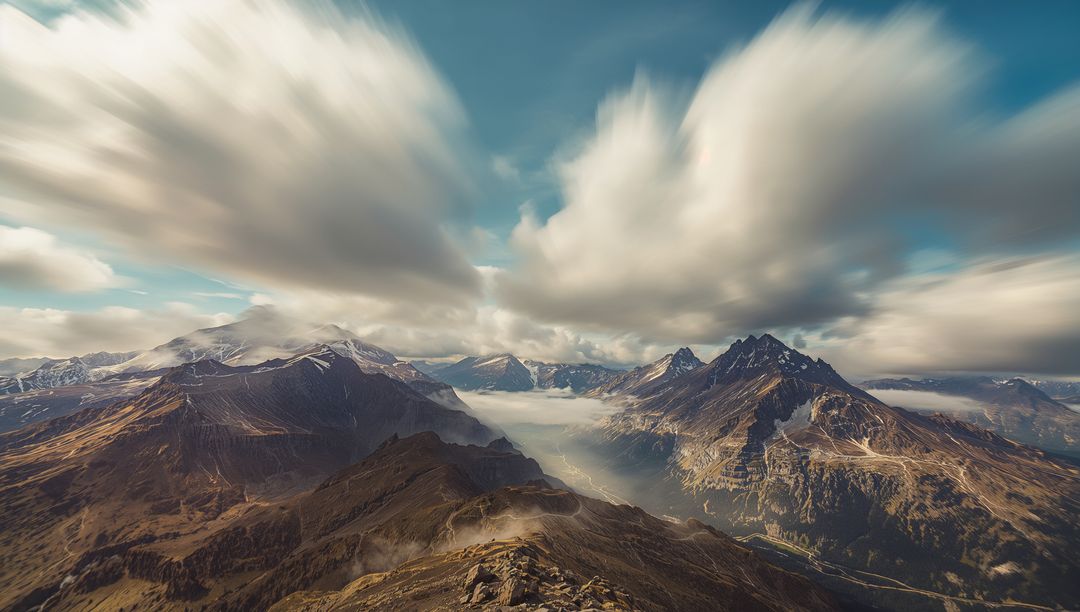 Dramatic Mountain Range with Layered Clouds and Misty Valleys