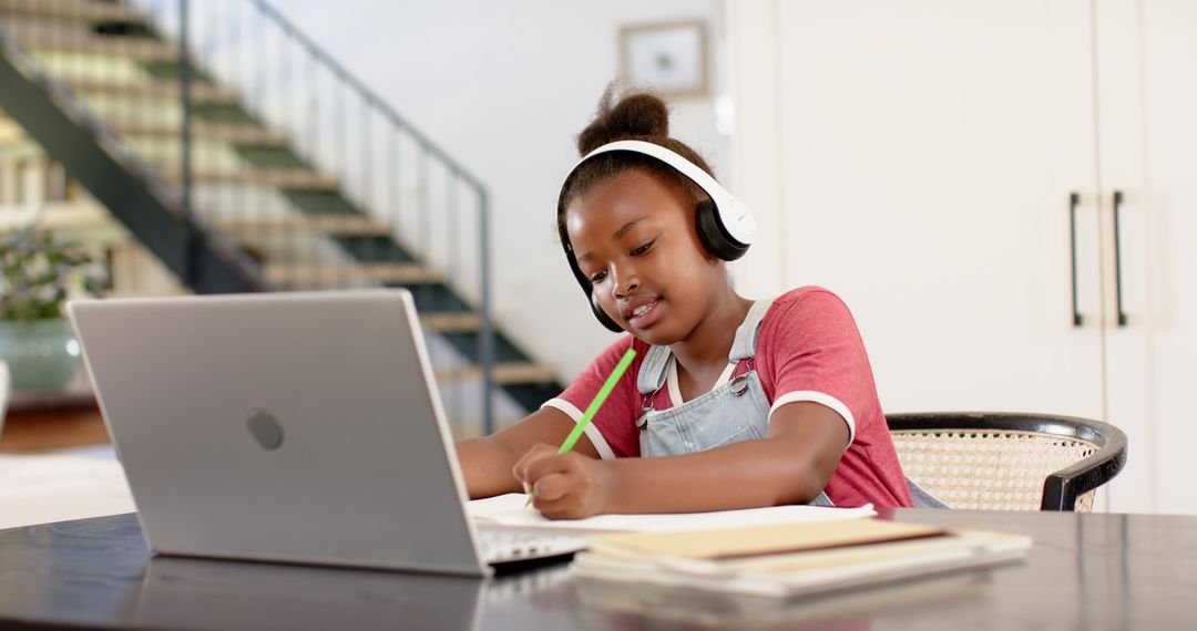 Child Using Laptop with Headphones for Online Learning