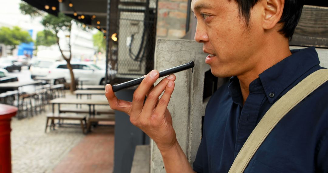 Man Using Smartphone Voice Recognition on Urban Street - Free Images, Stock Photos and Pictures on Pikwizard.com