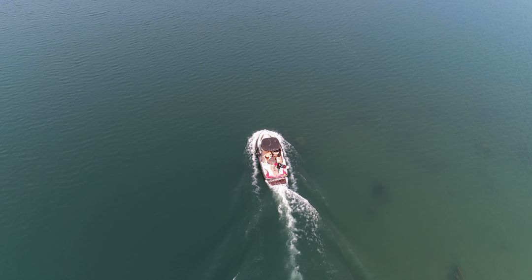 Aerial View of a Boat Cruising on Calm Lake Waters - Free Images, Stock Photos and Pictures on Pikwizard.com