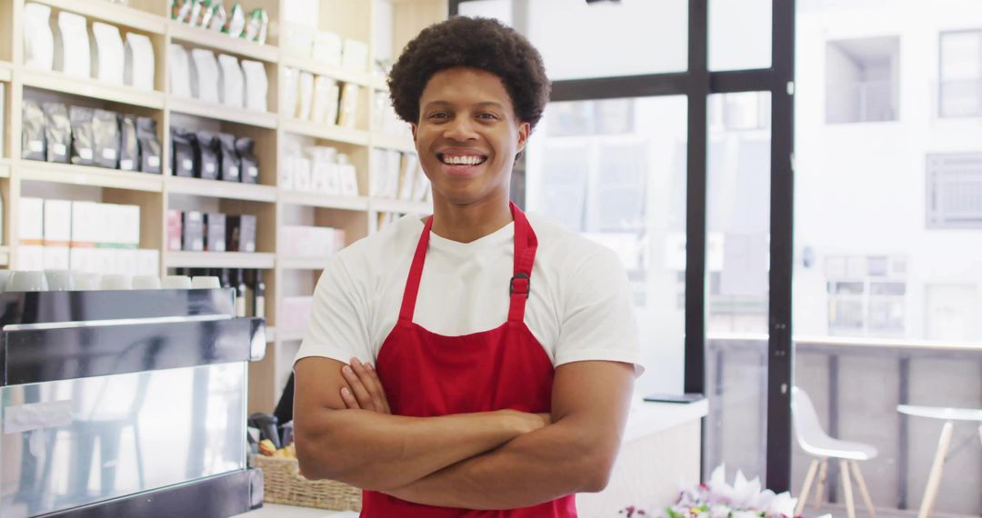 Smiling Barista Standing with Arms Crossed in Modern Coffee Shop