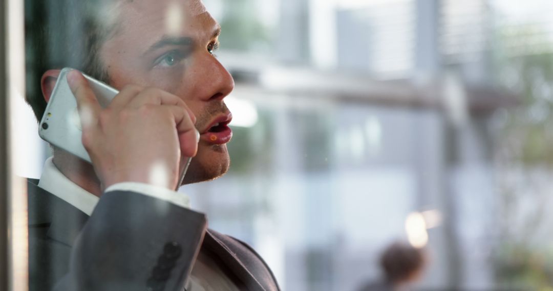 Businessman having an intense phone conversation at office - Free Images, Stock Photos and Pictures on Pikwizard.com