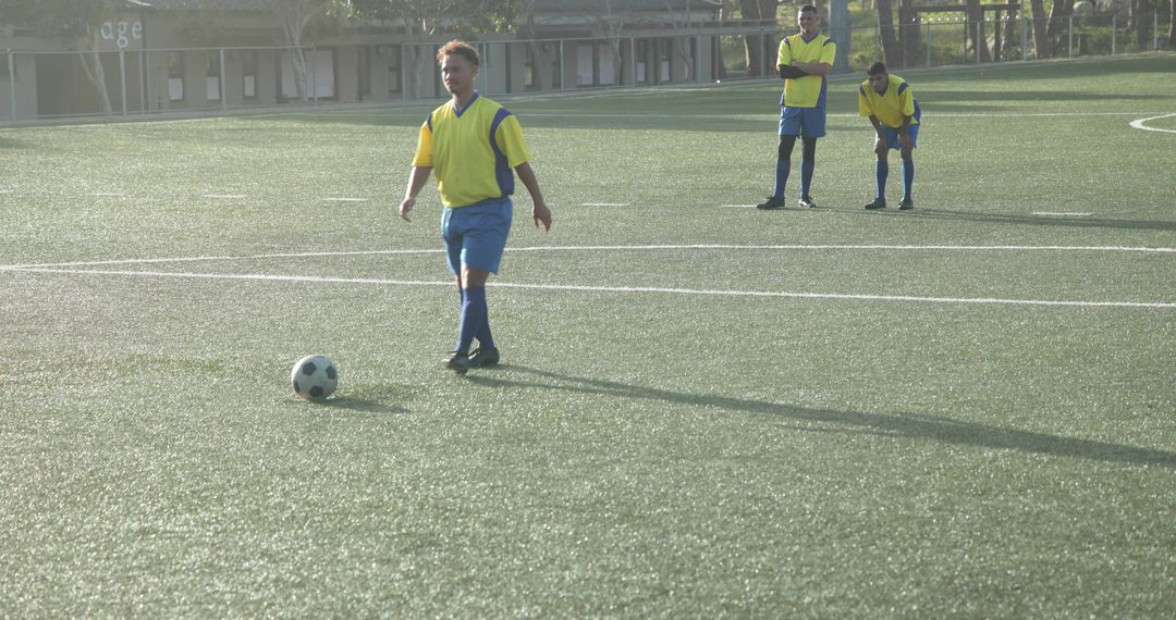 Youth Soccer Player Kicking Ball on Open Field During Practice