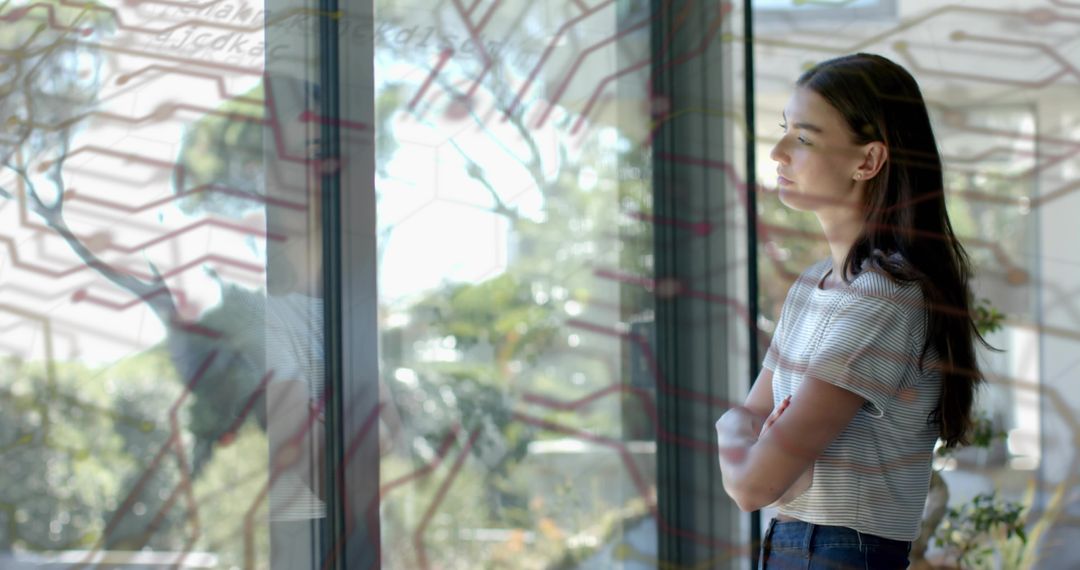 Young Woman Gazing Through Window with Circuit Hex Overlay and Sunlit Garden Reflection