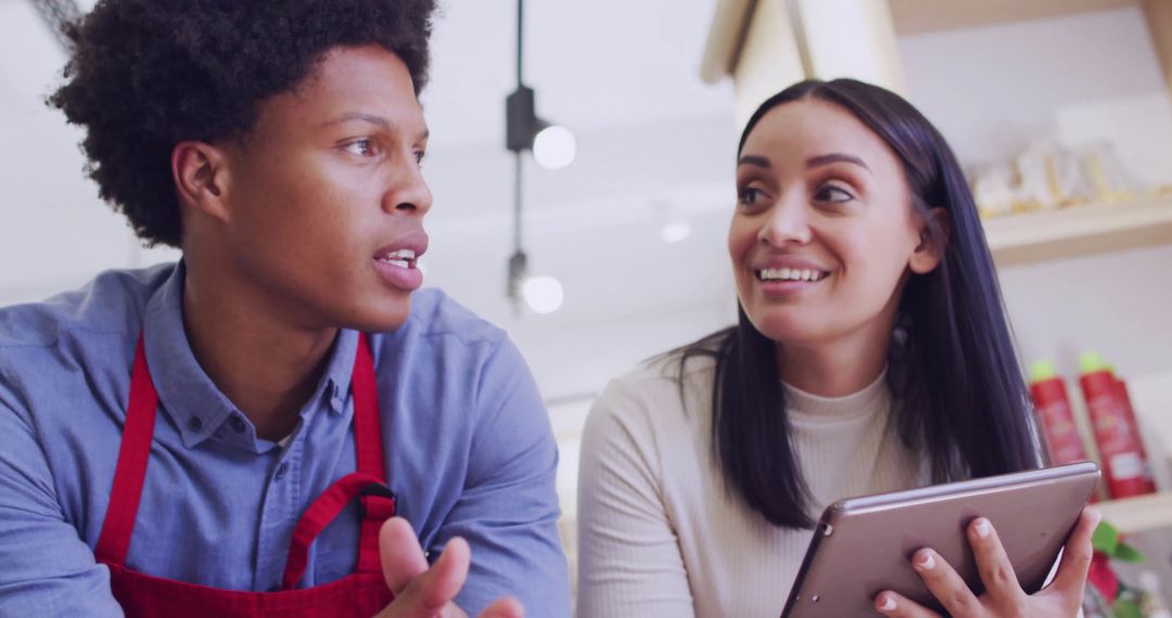 Collaboration in Modern Coffee Shop Setting with Tablet and Teamwork