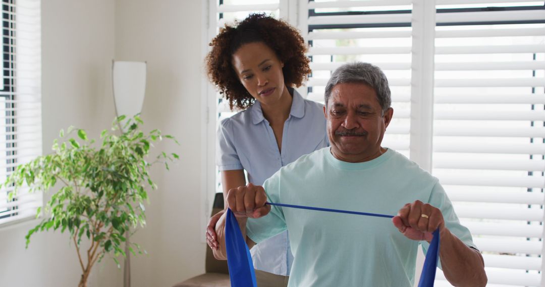 Senior Man Exercising with Physiotherapist Using Resistance Band - Free Images, Stock Photos and Pictures on Pikwizard.com