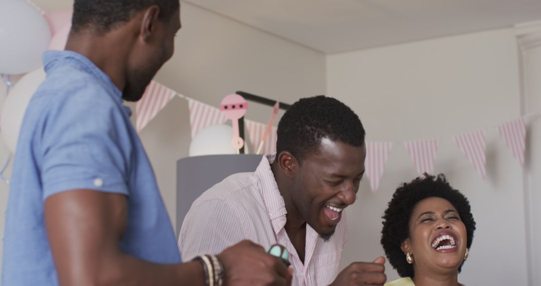 Friends Enjoying Laughter and Drinks at Fun Home Celebration