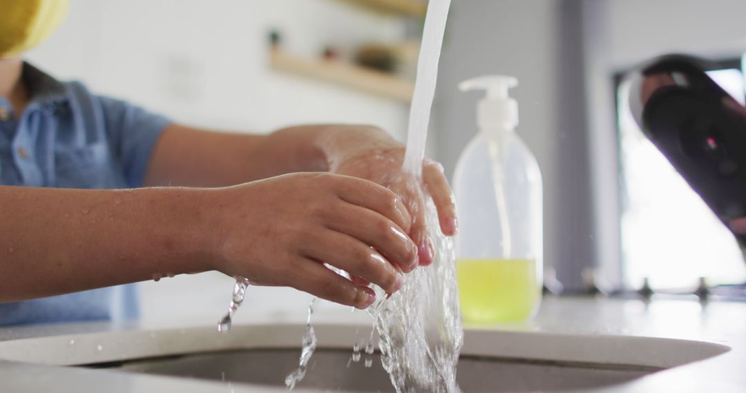 Child Washing Hands Under Running Water in Kitchen - Free Images, Stock Photos and Pictures on Pikwizard.com