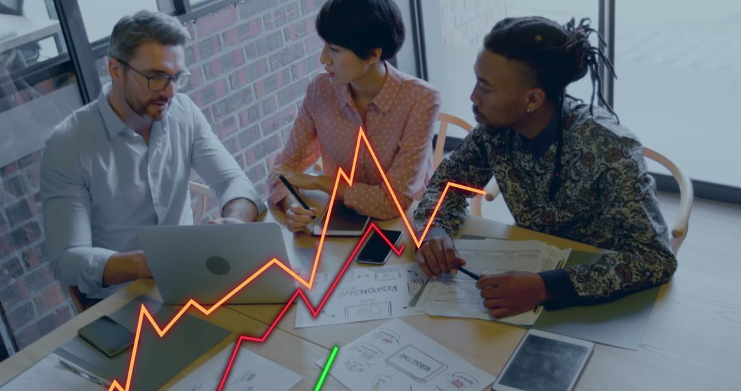 Diverse Team Analyzing Financial Graphs in Modern Office Setting