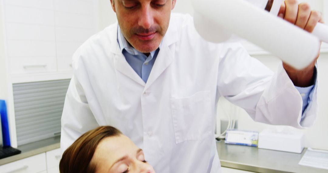 Dentist Examining Patient with X-Ray Equipment in Clinic - Free Images, Stock Photos and Pictures on Pikwizard.com