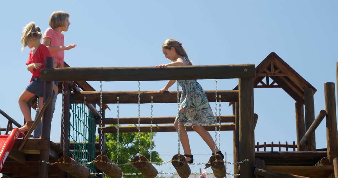 Children Exploring Wooden Playground Structure under Blue Sky