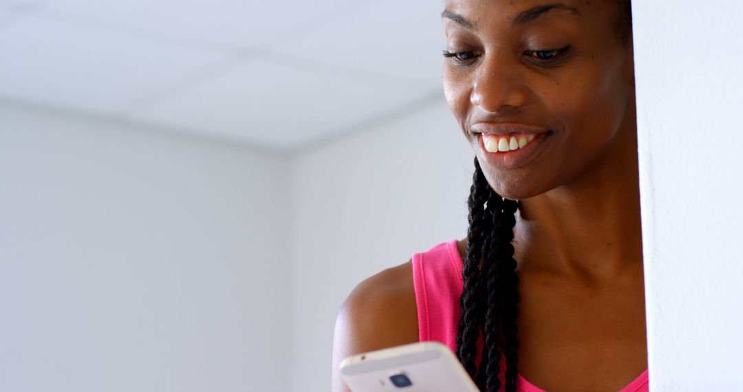 Woman Smiling While Using Smartphone Indoors - Free Images, Stock Photos and Pictures on Pikwizard.com