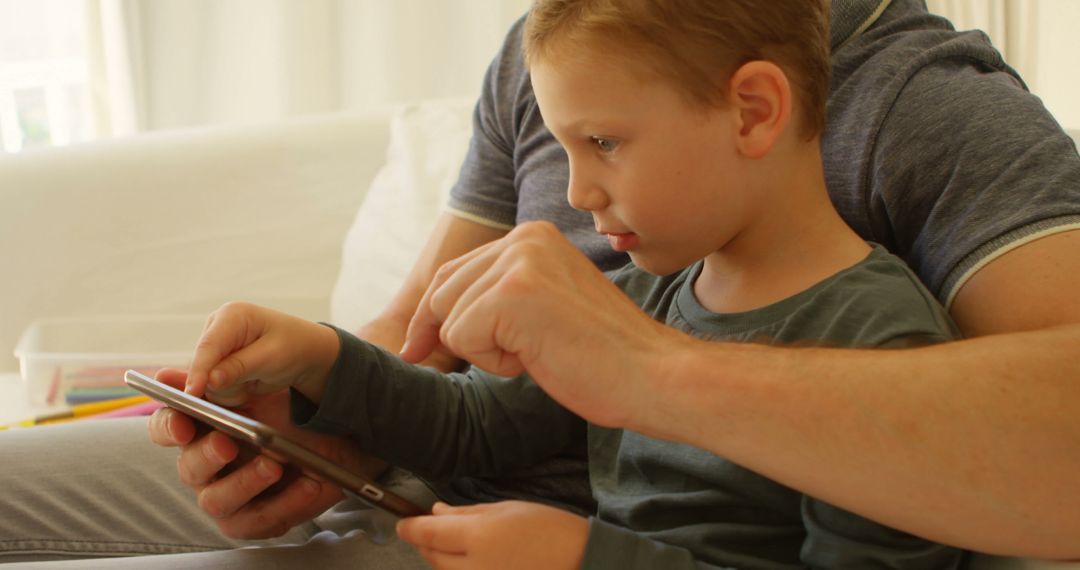 Father Teaching Young Son to Use Tablet at Home - Free Images, Stock Photos and Pictures on Pikwizard.com