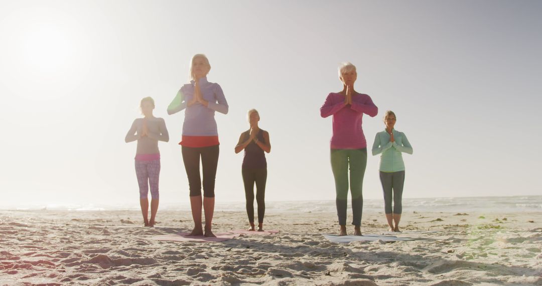 Senior Women Practicing Yoga Together On Beach Peaceful Morning - Free Images, Stock Photos and Pictures on Pikwizard.com