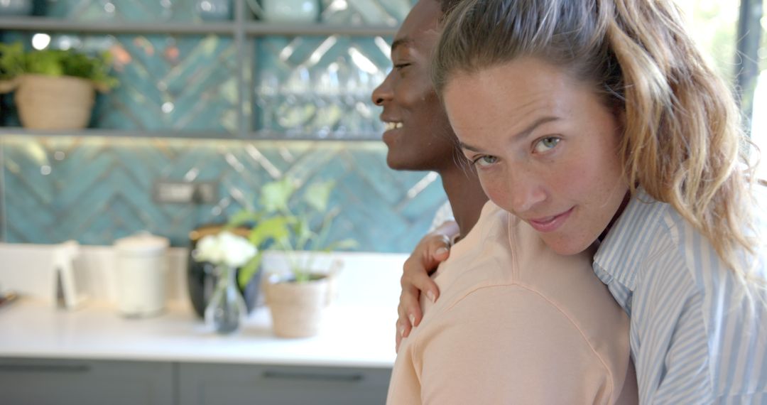 Diverse Couple Embracing in Modern Kitchen
