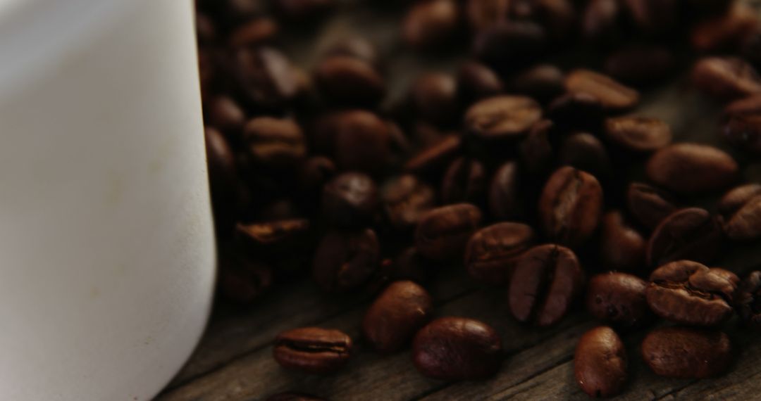 Close-up of Coffee Beans and Mug on Wooden Surface - Free Images, Stock Photos and Pictures on Pikwizard.com