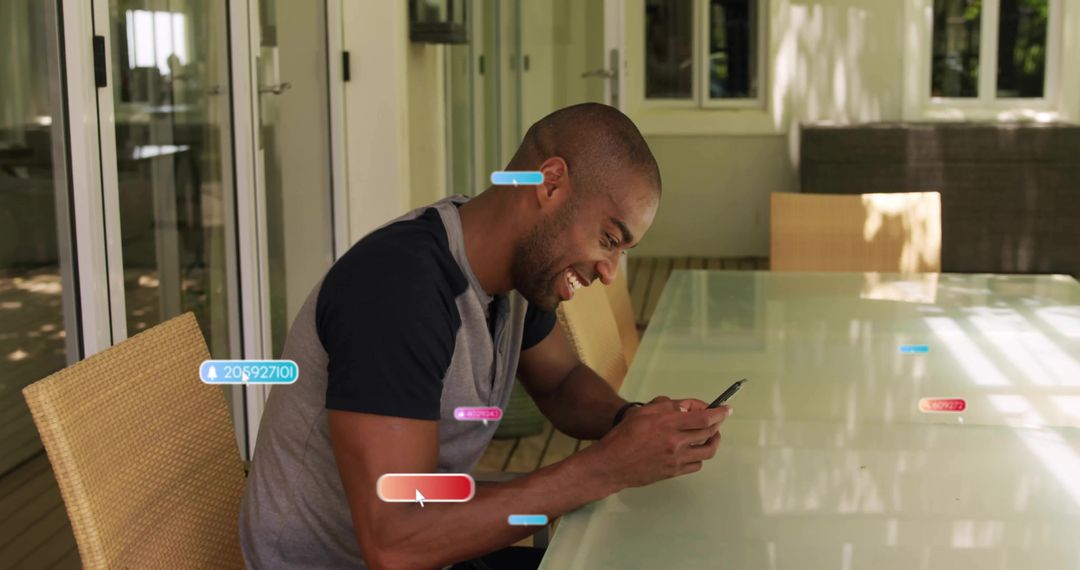 Man Enjoying Smartphone at Patio Table in Relaxing Outdoor Space
