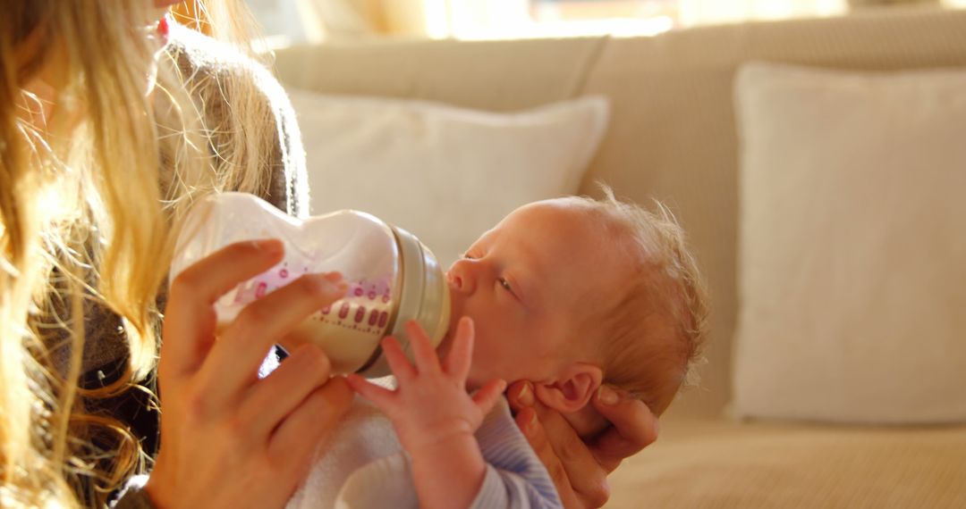 Mother Feeding Newborn Baby with Bottle at Home - Free Images, Stock Photos and Pictures on Pikwizard.com