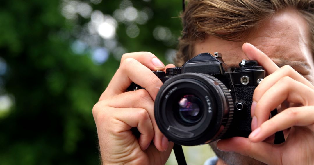 Man with Vintage Camera Creating Outdoor Photography - Free Images, Stock Photos and Pictures on Pikwizard.com