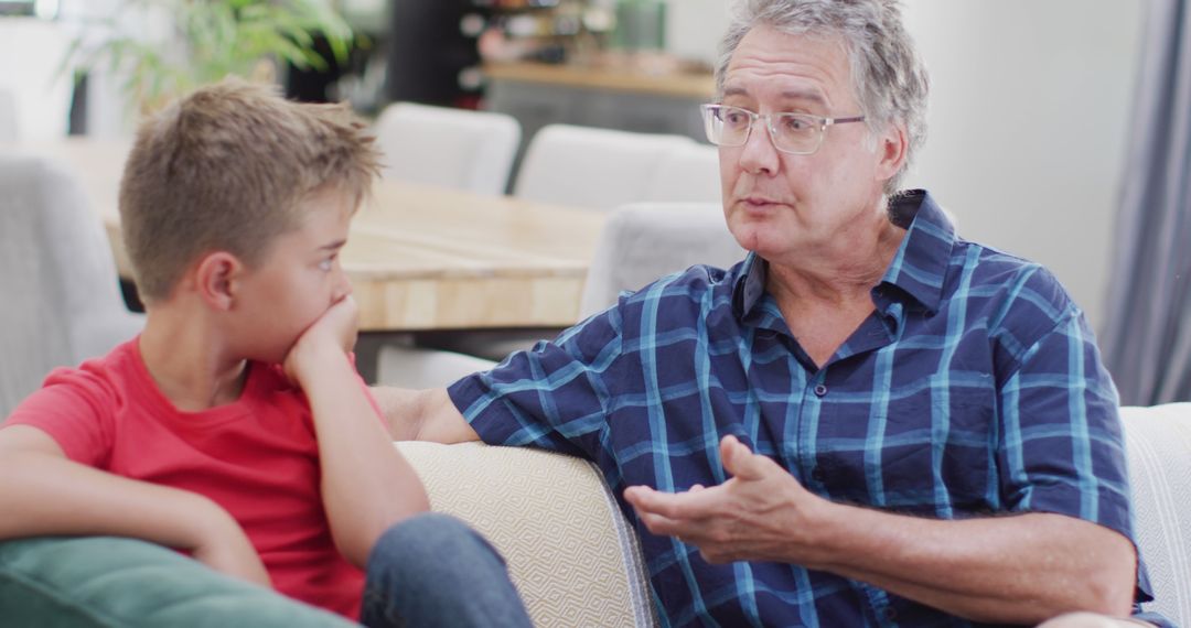 Grandfather Having Serious Conversation with Grandson at Home - Free Images, Stock Photos and Pictures on Pikwizard.com