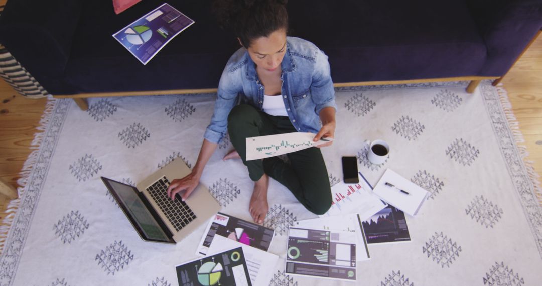 Businesswoman Analyzing Data with Laptop and Charts in Cozy Office