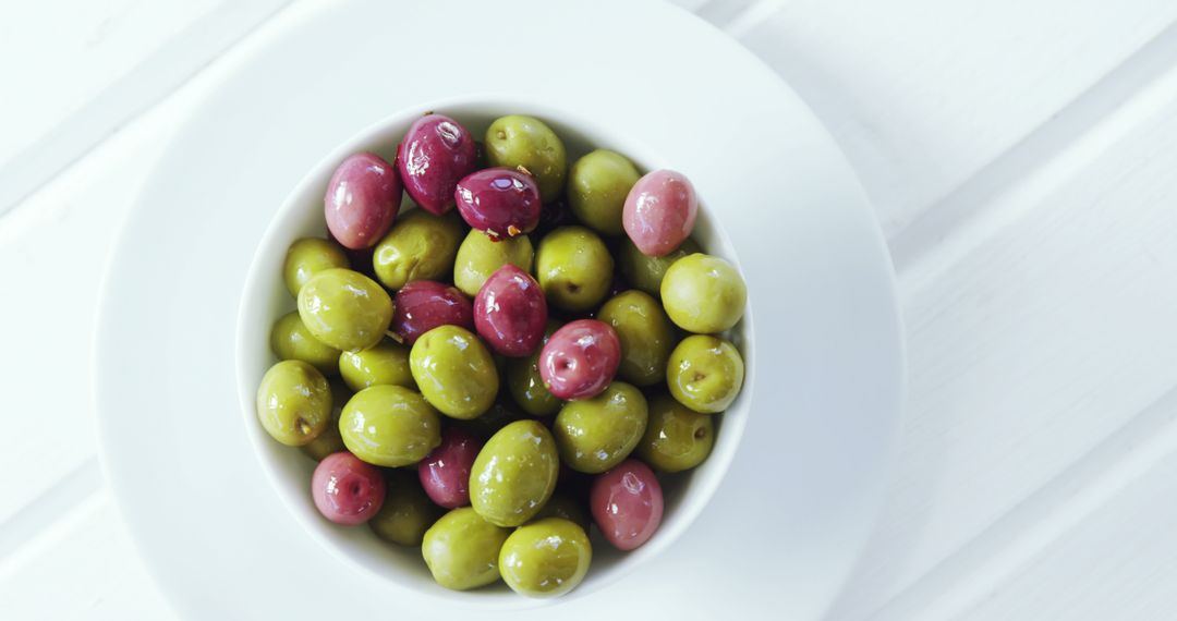 Colorful Mixed Olives in White Bowl on Rustic White Table - Free Images, Stock Photos and Pictures on Pikwizard.com