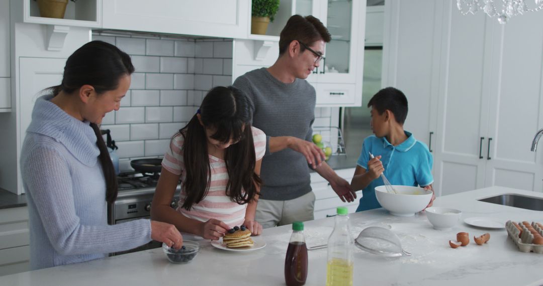 Family Making Breakfast Together in Modern Kitchen - Free Images, Stock Photos and Pictures on Pikwizard.com