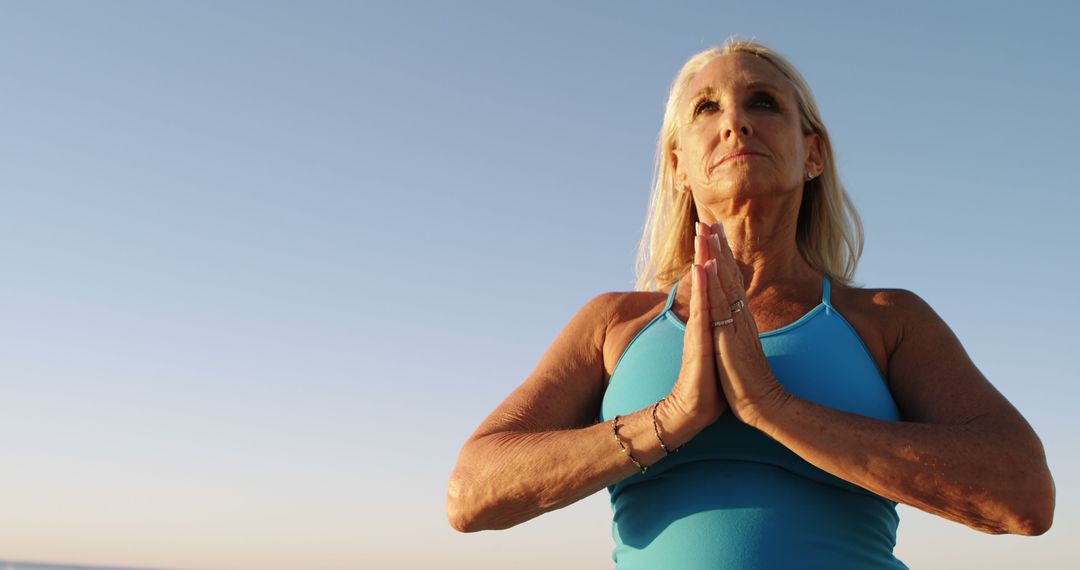 Senior Woman Practicing Yoga Outdoors at Sunset - Free Images, Stock Photos and Pictures on Pikwizard.com