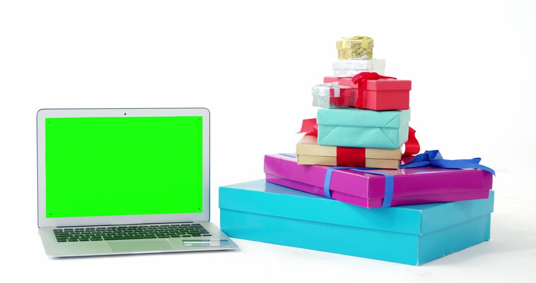 Laptop with Green Screen and Gift Boxes Pile on White Background - Free Images, Stock Photos and Pictures on Pikwizard.com