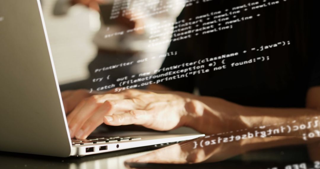 Close-Up of Hands Coding on Laptop with Digital Overlay