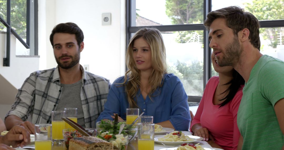Group of Friends Enjoying Casual Meal at Home Gathering