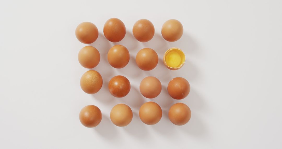 Top View of Grid Arrangement of Brown Eggs with One Broken - Free Images, Stock Photos and Pictures on Pikwizard.com