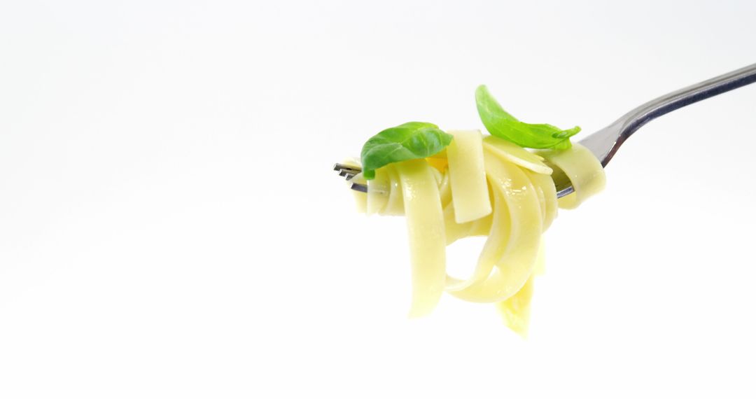 Close-Up Fork with Fettuccine Pasta and Fresh Basil Leaves - Free Images, Stock Photos and Pictures on Pikwizard.com