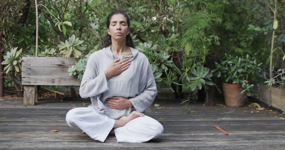 Woman Practicing Mindful Meditation Outdoors in a Tranquil Garden - Free Images, Stock Photos and Pictures on Pikwizard.com