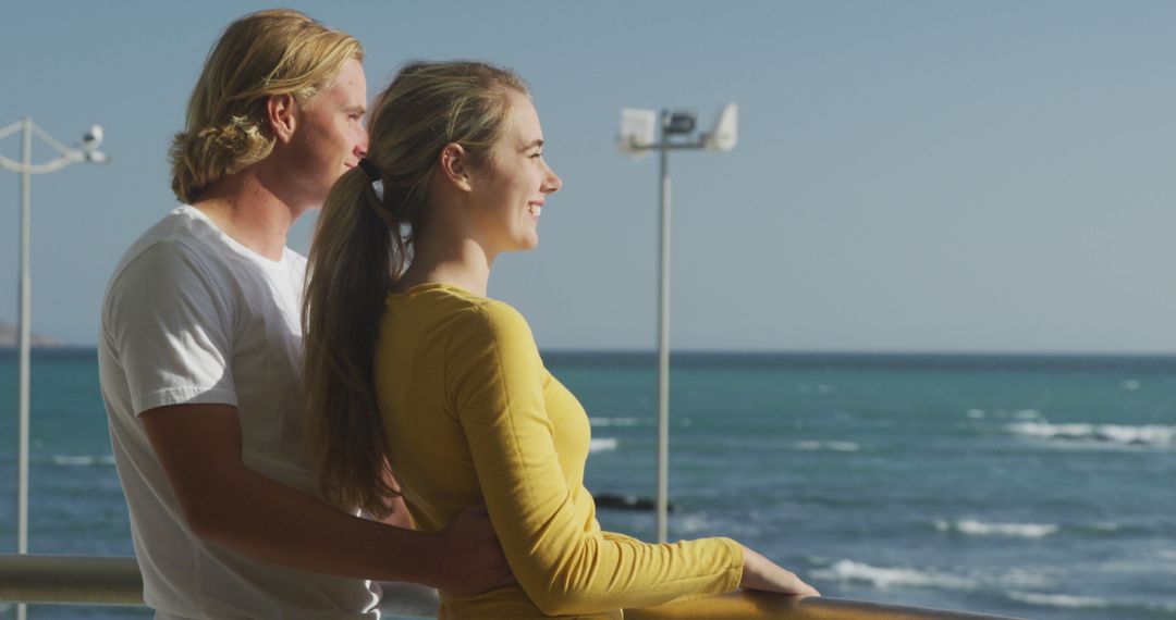 Smiling Couple Admiring Ocean View on Sunny Day - Free Images, Stock Photos and Pictures on Pikwizard.com