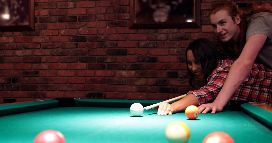Friends Enjoying a Casual Game of Pool in Cozy Atmosphere