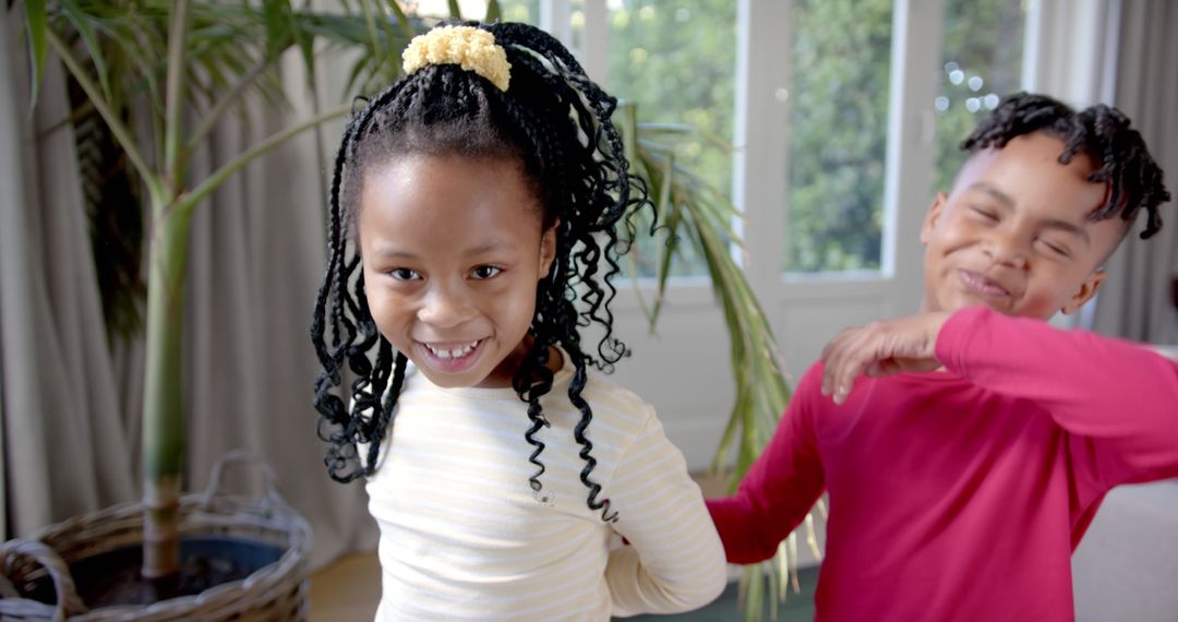 Joyful Siblings Playing Together at Home