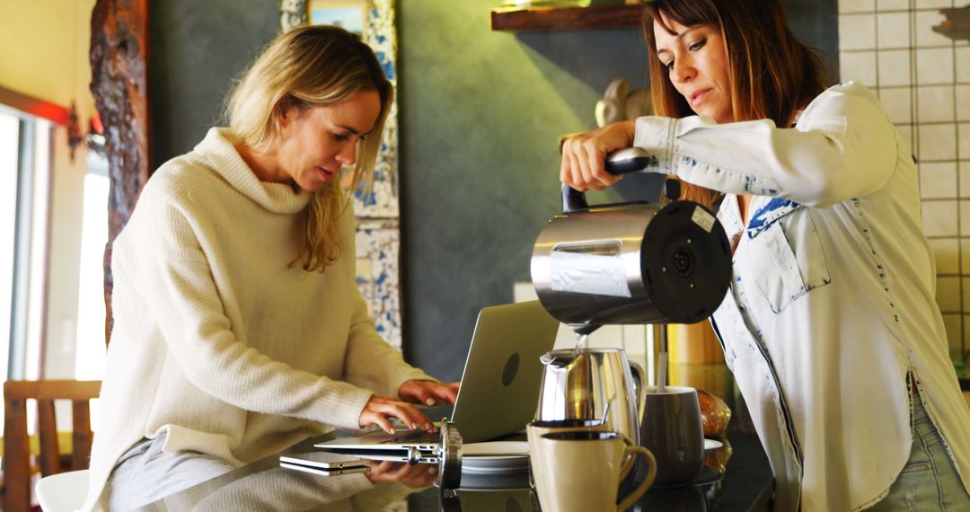 Two Women in Cozy Kitchen, Freelancing and Pouring Coffee - Free Images, Stock Photos and Pictures on Pikwizard.com