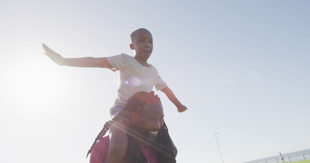 Father Carrying Son on Shoulders at Sunset - Free Images, Stock Photos and Pictures on Pikwizard.com