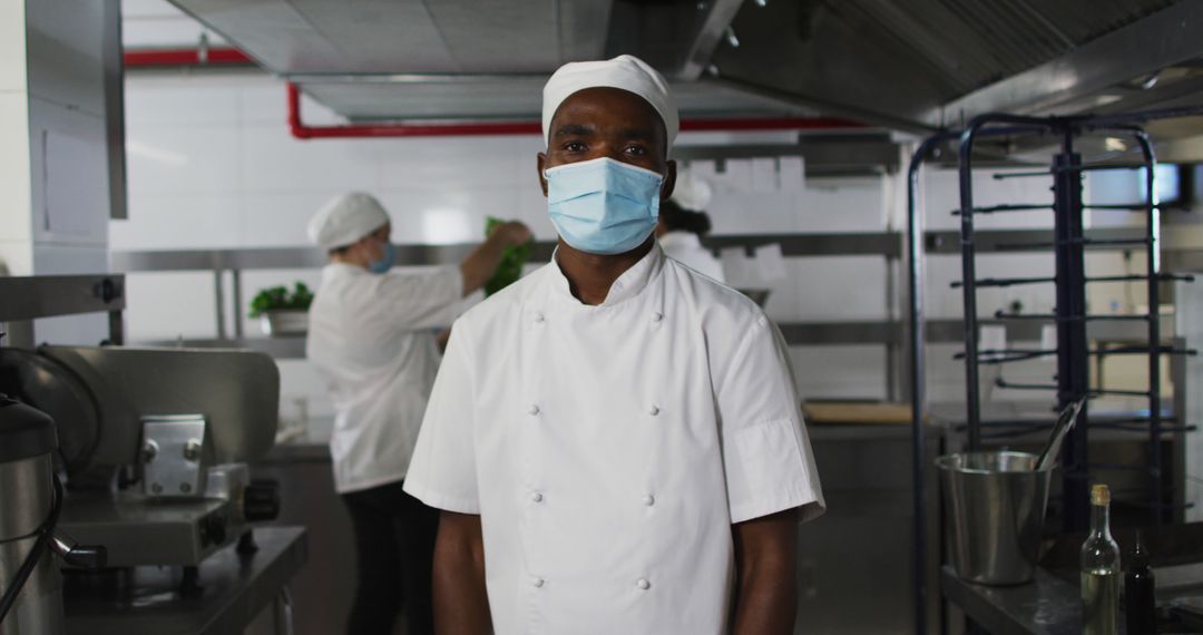 Portrait of african american male chef wearing face mask with arms crossed - Free Images, Stock Photos and Pictures on Pikwizard.com