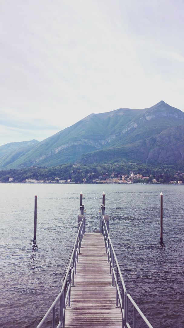 Scenic Pier Extending into Calm Mountain Lake - Free Images, Stock Photos and Pictures on Pikwizard.com