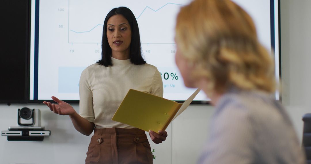 Confident Businesswoman Presenting Data in Meeting Room - Free Images, Stock Photos and Pictures on Pikwizard.com