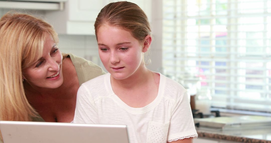 Mother Helping Daughter with Online Learning at Home - Free Images, Stock Photos and Pictures on Pikwizard.com