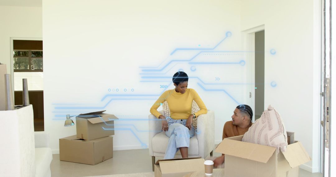 Young couple unpacking moving boxes and relaxing in modern living room during home setup