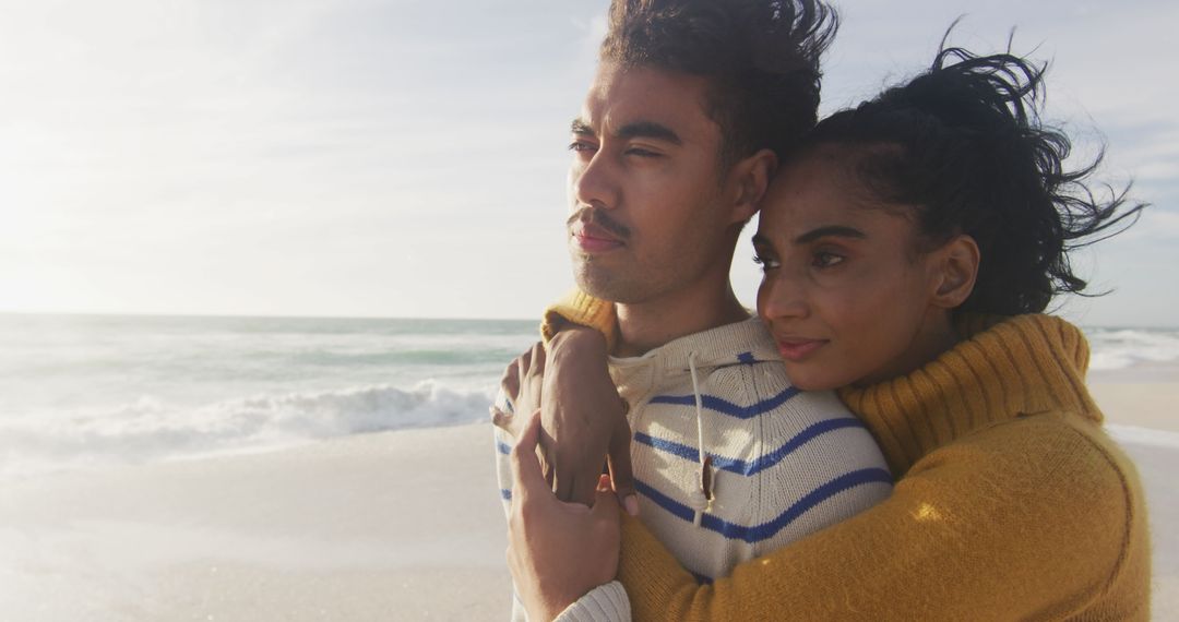 Couple Embracing on Serene Beachfront at Sunset