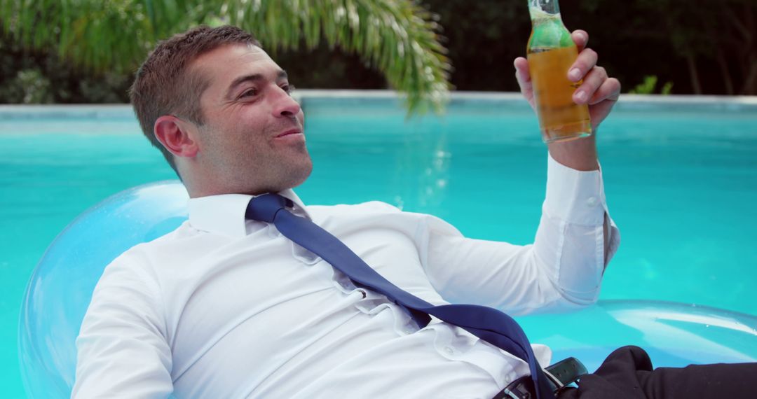 Businessman Enjoying Beer While Relaxing in Pool - Free Images, Stock Photos and Pictures on Pikwizard.com