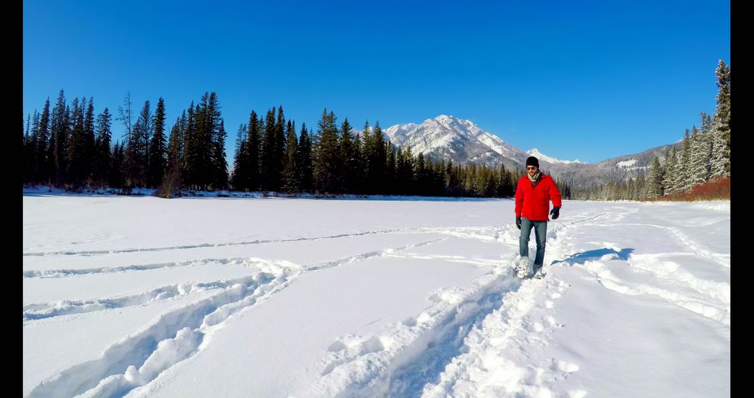 Man Enjoying Snowy Hike in Scenic Winter Landscape - Free Images, Stock Photos and Pictures on Pikwizard.com