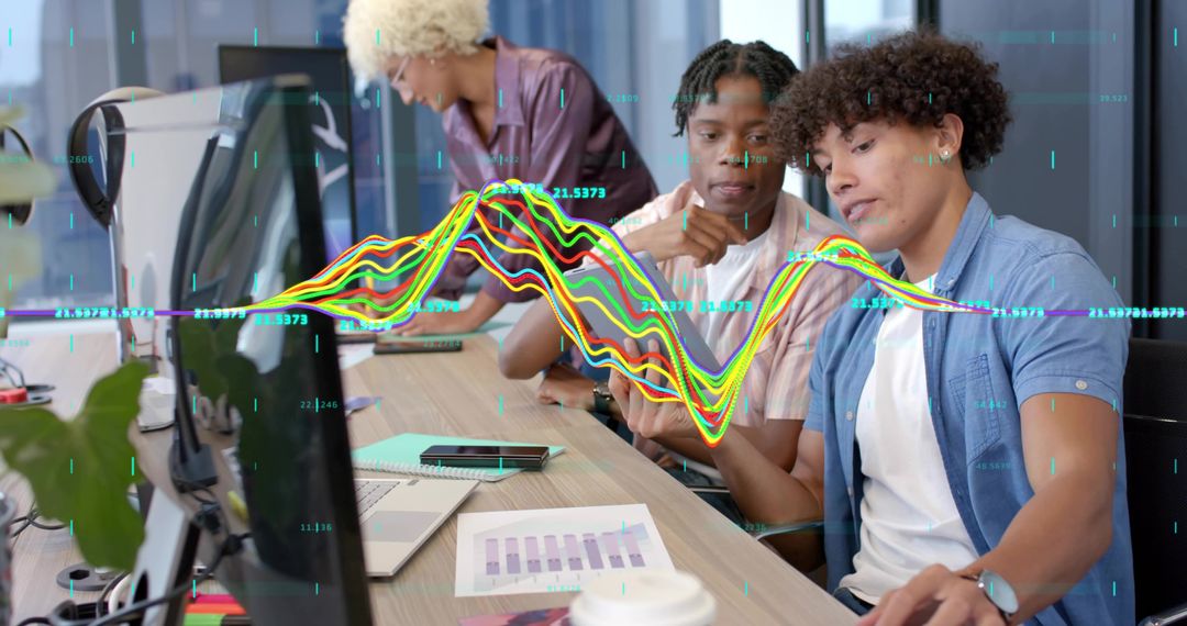 Young professionals collaborating on data analysis with colorful waveform visualization