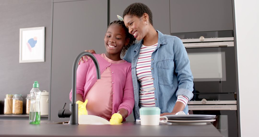 Smiling African American Mother and Daughter Washing Dishes in Kitchen Embracing - Free Images, Stock Photos and Pictures on Pikwizard.com